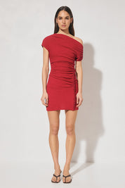 One-shoulder textured jersey mini dress with skimming fit, multi-wear draped neckline, gathered capped sleeve, cascading gathers, contrast frill hip panel, and figure-hugging mini skirt