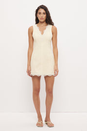 Sleeveless denim mini dress with V-neckline and scallop lace trim detail