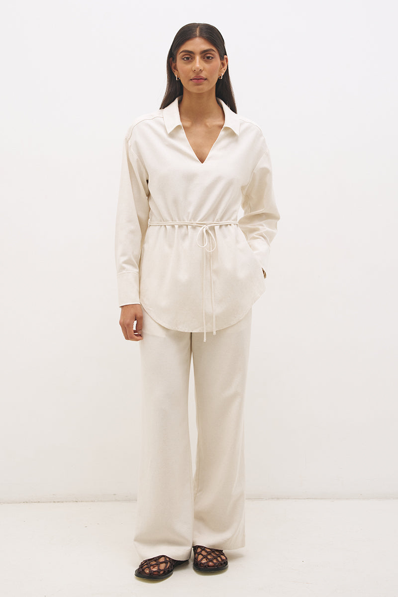 Woman wearing satin-backed linen blend wide leg pants with high-rise fit, scarf waist tie, elasticated back waistband, and relaxed tailored silhouette