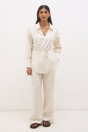 Woman wearing satin-backed linen blend wide leg pants with high-rise fit, scarf waist tie, elasticated back waistband, and relaxed tailored silhouette