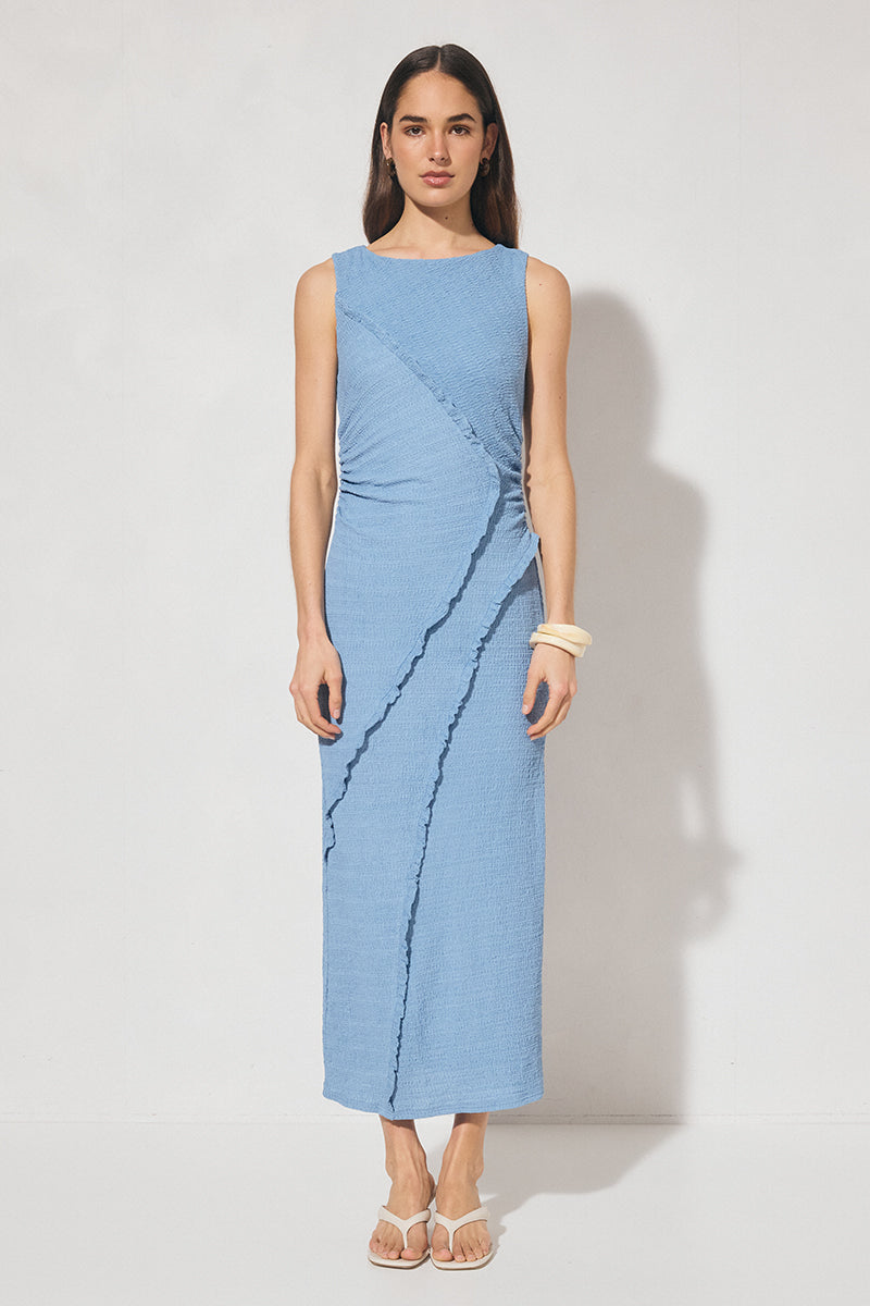 Sleeveless midi dress in textured jersey with skimming column silhouette, boat neckline, waist gathering, contrast frill panel detailing, and side seam split