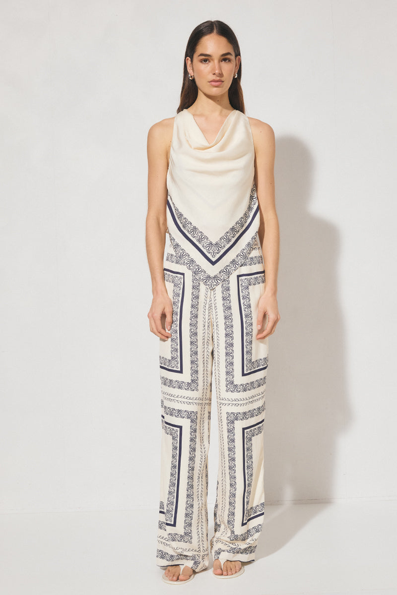 Sleeveless bias top with handcrafted placement print, cowled neckline, handkerchief hemline, and centre-back keyhole