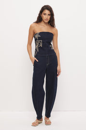 Strapless stretch denim top with straight neckline, contrast embroidery, bust darts, and exposed back zipper