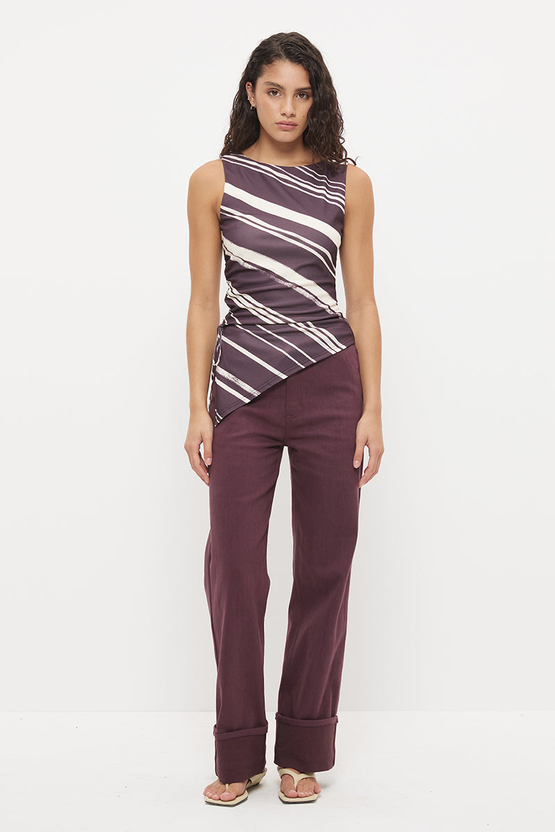 Sleeveless longline top with asymmetrical hemline, boat neckline and cascading waist ruching in exclusive handcrafted print