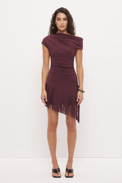Off-shoulder mini dress in stretch knit crepe with asymmetrical neckline and angled fringe hem detail