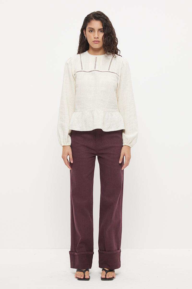 Long sleeve seersucker blouse with scalloped round neckline, balloon sleeves and lace-trimmed peplum hem