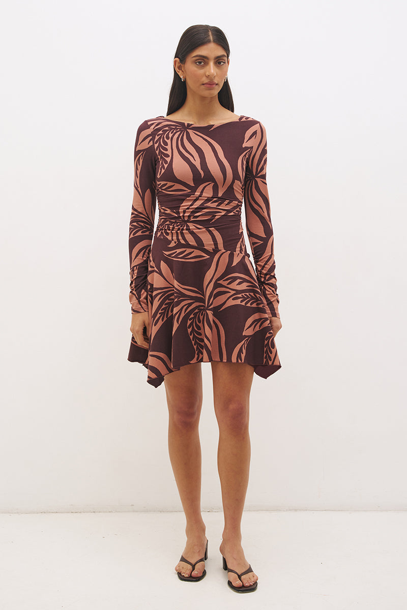 Printed handkerchief hem mini dress with boat neckline, ruched long sleeves, gathered bodice, and hi-lo draped skirt in stretch modal jersey