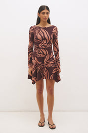 Printed handkerchief hem mini dress with boat neckline, ruched long sleeves, gathered bodice, and hi-lo draped skirt in stretch modal jersey