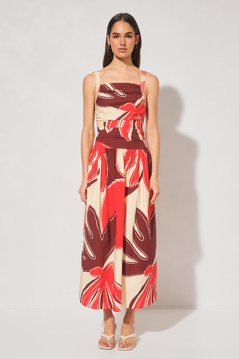Handcrafted print strappy maxi dress with ruched bodice, dropped waist, gathered skirt, adjustable straps, and apron neckline