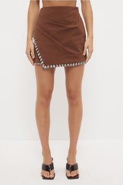 High waisted mini skirt in textured stretch cotton with two-tone fringed hem