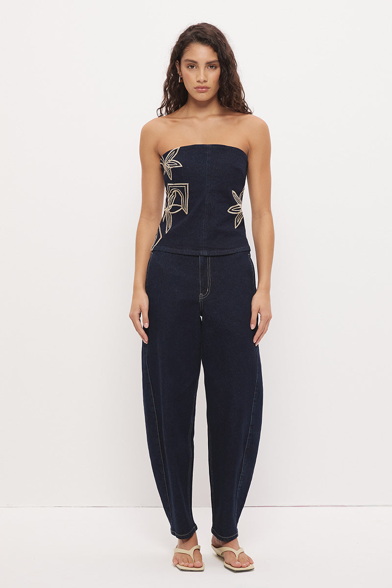 High-rise stretch denim barrel leg jeans with curved silhouette, contrast topstitching, and panelled construction