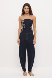 High-rise stretch denim barrel leg jeans with curved silhouette, contrast topstitching, and panelled construction