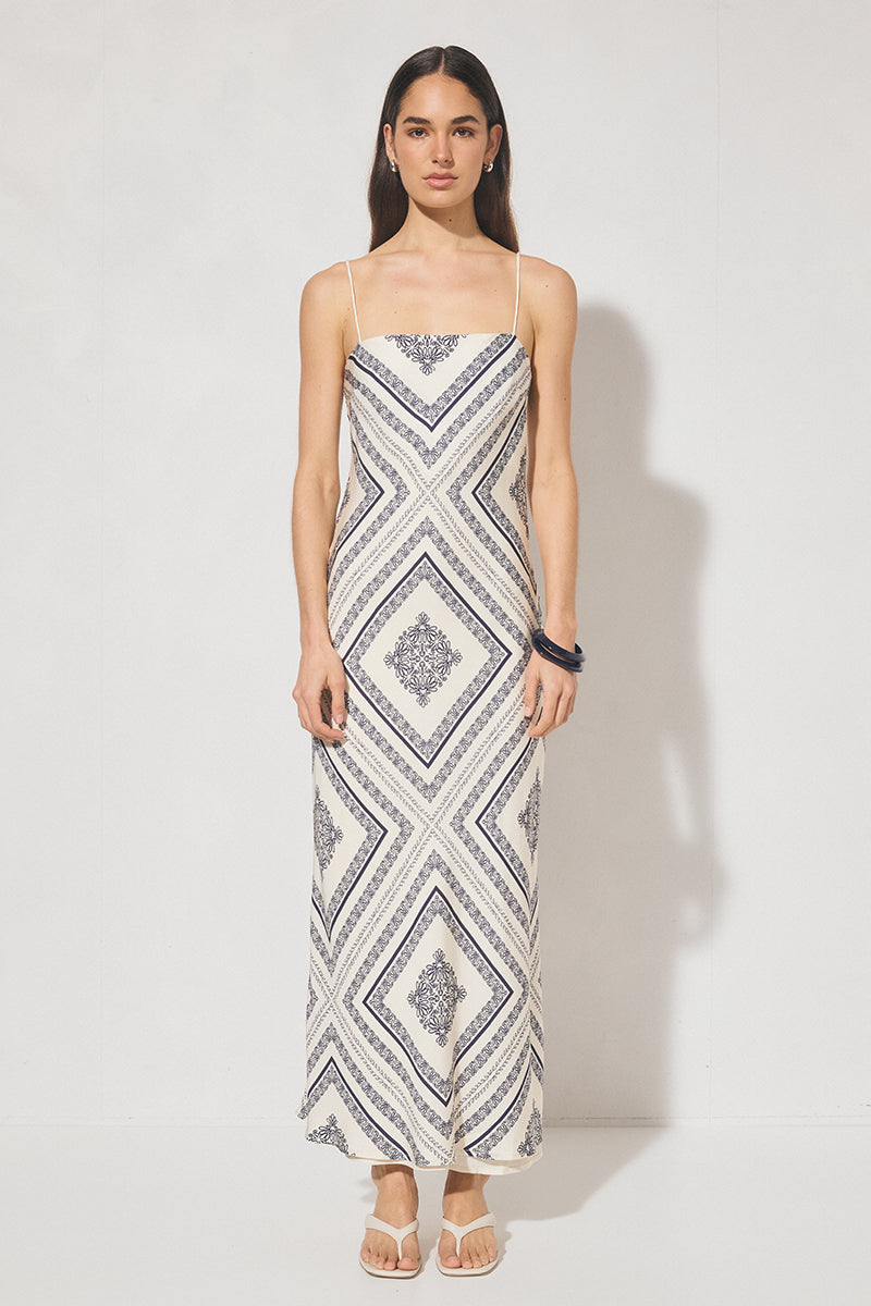 Bias cut maxi slip dress with handcrafted placement print, straight neckline, handkerchief front panel, and adjustable multiwear straps