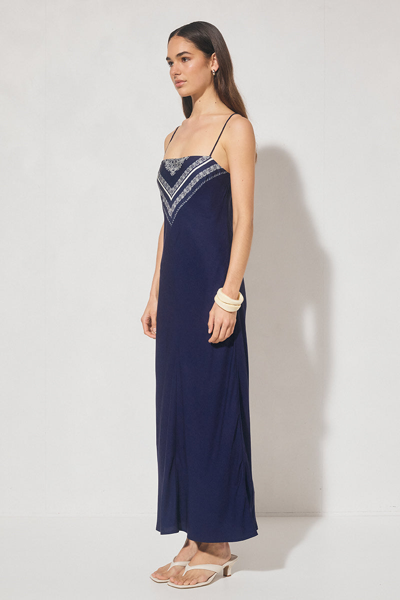 Bias cut maxi slip dress with handcrafted placement print, straight neckline, handkerchief front panel, and adjustable multiwear straps