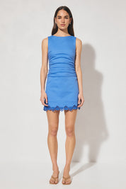 Sleeveless mini dress with scalloped embroidery, narrow boat neckline, gathered waist, and wide back cut-out with rouleau tie closure