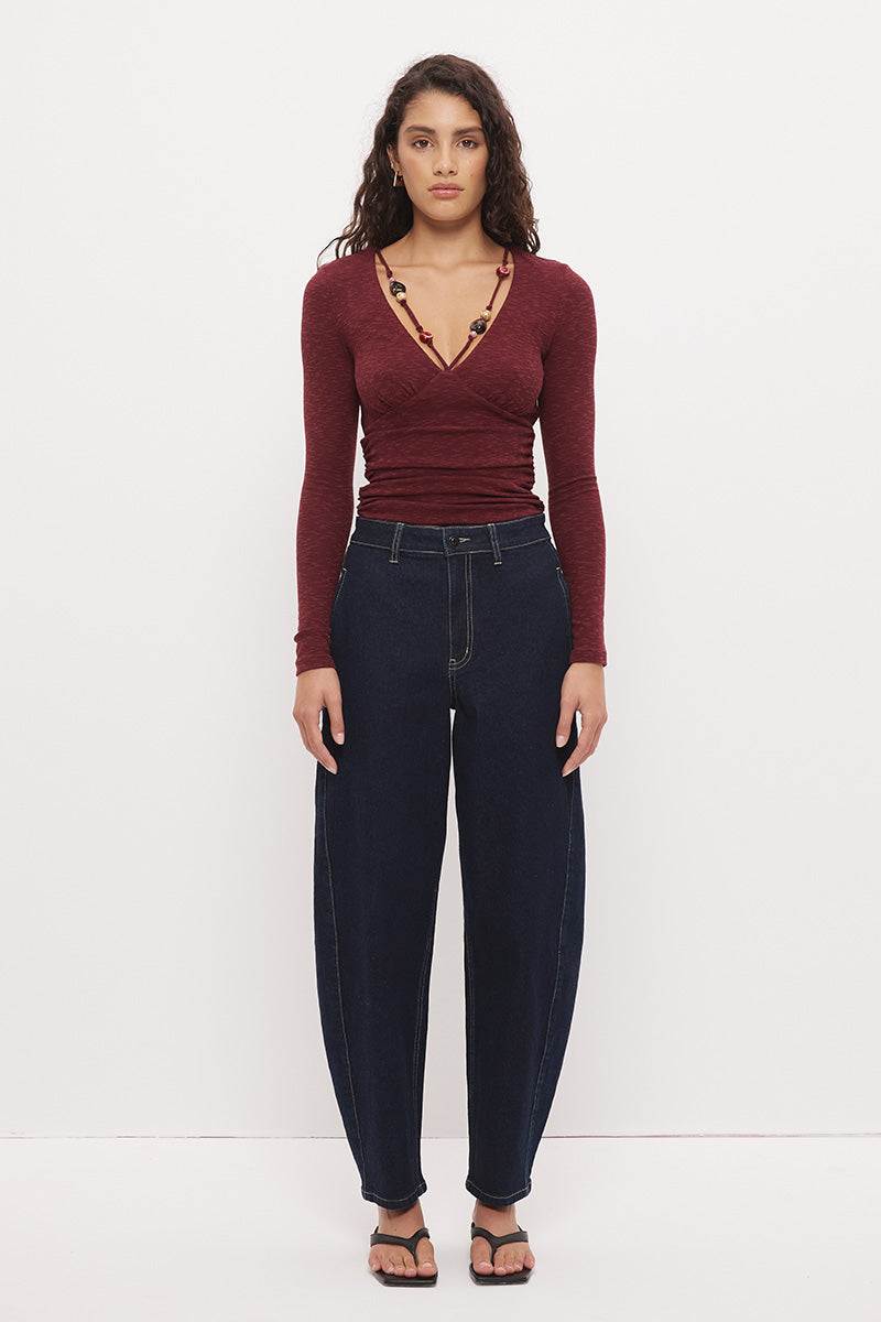 Long sleeve textured jersey fitted top with V-neckline, beaded strap detail, empire waist, and soft waist gathering