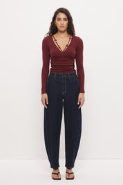 Long sleeve textured jersey fitted top with V-neckline, beaded strap detail, empire waist, and soft waist gathering