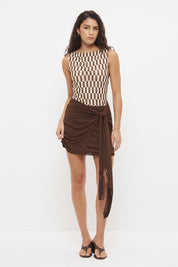 Bodycon mini dress with printed bodice, contrast sarong skirt and macrame tassel tie