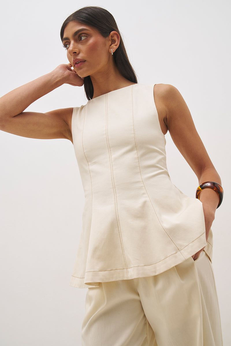 Sleeveless cotton twill top with fit and flare silhouette, open back tie detail and circle cut hem