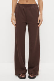Woman wearing embroidered fleeced-back jersey sweatpants in a regular straight leg fit with contrast side seam embroidery and a topstitched elasticated waistband.