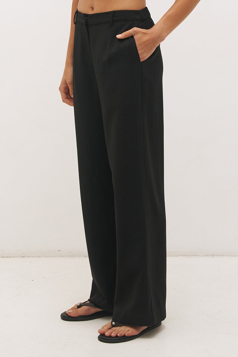 Woman wearing high-rise wide leg pants in a satin-backed linen blend with a tie-up belt featuring bead and ring detail.