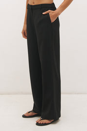 Woman wearing high-rise wide leg pants in a satin-backed linen blend with a tie-up belt featuring bead and ring detail.
