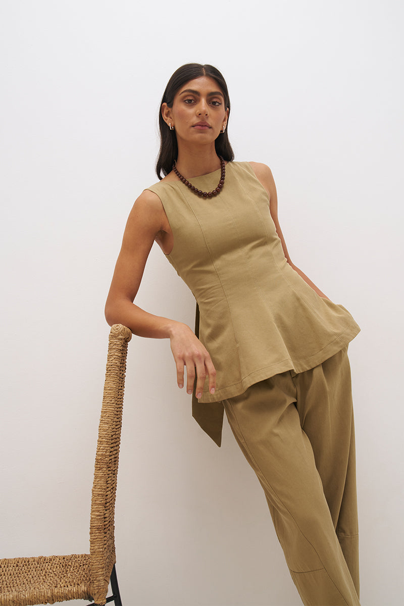 Sleeveless cotton twill top with fit and flare silhouette, open back tie detail and circle cut hem