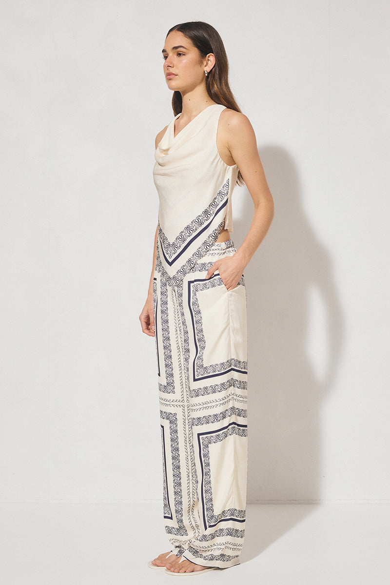 Sleeveless bias top with handcrafted placement print, cowled neckline, handkerchief hemline, and centre-back keyhole