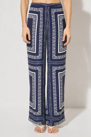 High-waisted tailored woven pants with handcrafted print, straight-leg silhouette, narrow waistband, and side seam pockets