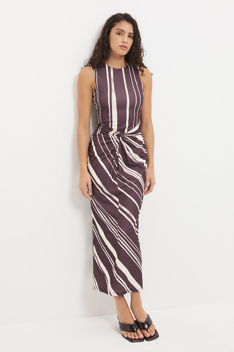 Sleeveless midi dress with fitted column silhouette, twisted knot detail and cascading ruching in exclusive handcrafted print