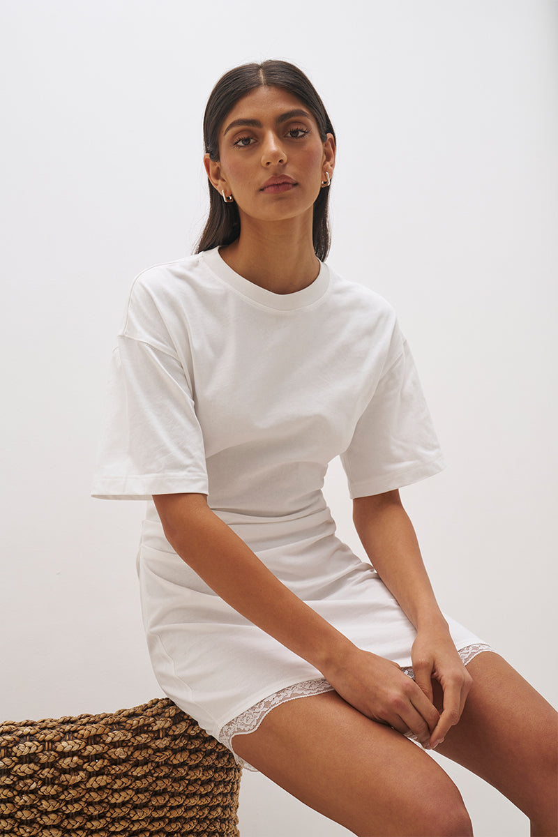 Cotton jersey tee mini dress with cinched waist, fitted skirt, side split and lace trim angled hem