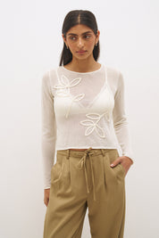 Semi sheer knitted long sleeve top with floral appliqué, jewel neckline and skimming fit