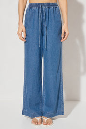 Wide-leg denim jeans with elastic waistband, cornelli piping, slant front pockets, back welt pockets, and heavy topstitching