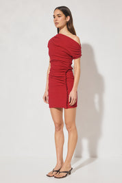 One-shoulder textured jersey mini dress with skimming fit, multi-wear draped neckline, gathered capped sleeve, cascading gathers, contrast frill hip panel, and figure-hugging mini skirt