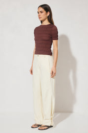 Skimming fit knitted tee shirt with round neckline, short sleeves, horizontal shirring detail, and narrow ribbed trims