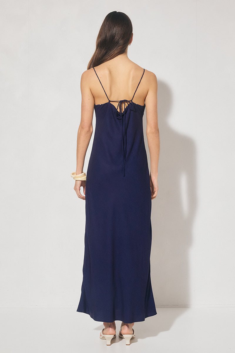 Bias cut maxi slip dress with handcrafted placement print, straight neckline, handkerchief front panel, and adjustable multiwear straps