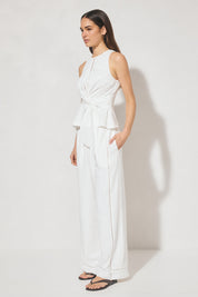 Sleeveless textured woven top with crew neckline, ladder trim detail, twisted waist sash, and side seam splits