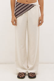 Woman wearing satin-backed linen blend wide leg pants with high-rise fit, scarf waist tie, elasticated back waistband, and relaxed tailored silhouette