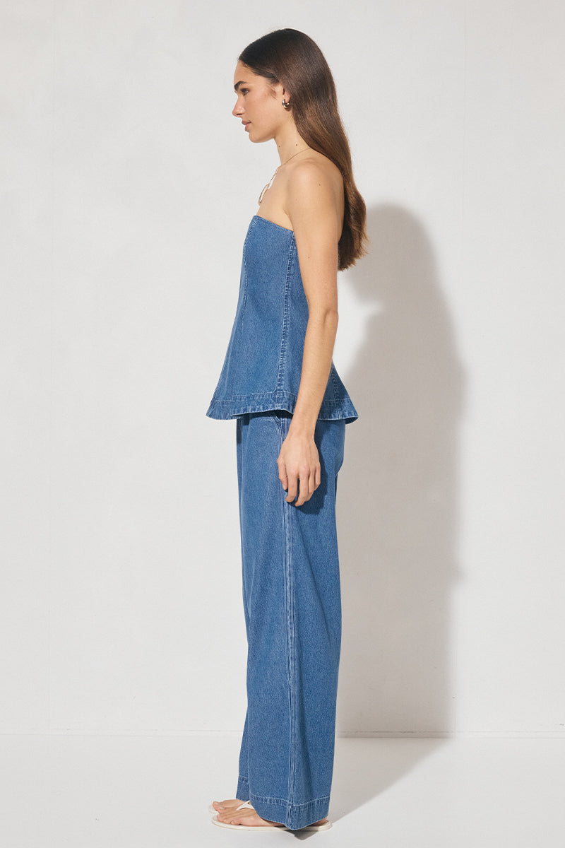 Strapless denim fit-and-flare top with cornelli piping, princess seams, flared circle-cut hem, and centre-back zipper