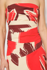 Strapless cotton blend bustier top with straight neckline, angled torso tucks, encased boning, elasticated back panels, and open-ended zipper