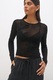 Semi sheer knitted long sleeve top with floral appliqué, jewel neckline and skimming fit