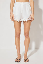 High-waisted tailored shorts with scalloped embroidery, front slant pockets, elasticated back waist, and front zipper closure