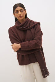 Woman wearing oversized scarf knit jumper with removable tassel scarf, crew neckline, ribbed trims, and relaxed silhouette