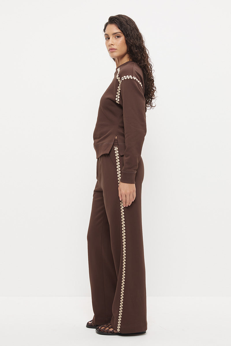 Embroidered fleeced-back sweatshirt with crew neckline, dropped shoulders, waist tucks, and ribbed hem band