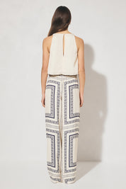 Sleeveless bias top with handcrafted placement print, cowled neckline, handkerchief hemline, and centre-back keyhole