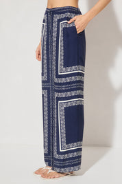 High-waisted tailored woven pants with handcrafted print, straight-leg silhouette, narrow waistband, and side seam pockets