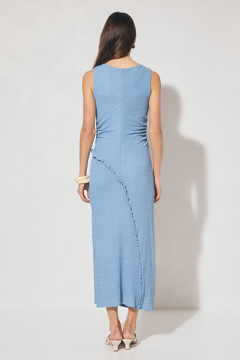 Sleeveless midi dress in textured jersey with skimming column silhouette, boat neckline, waist gathering, contrast frill panel detailing, and side seam split