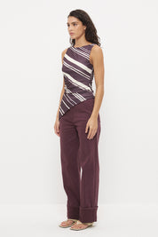 Sleeveless longline top with asymmetrical hemline, boat neckline and cascading waist ruching in exclusive handcrafted print