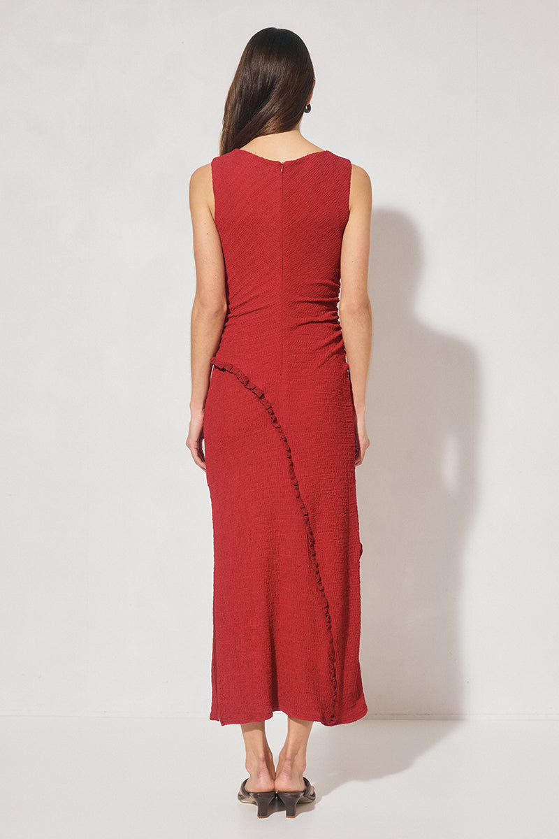 Sleeveless midi dress in textured jersey with skimming column silhouette, boat neckline, waist gathering, contrast frill panel detailing, and side seam split