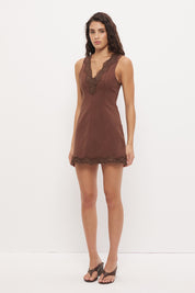 Sleeveless denim mini dress with V-neckline and scallop lace trim detail